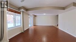 Unfurnished room with concrete flooring and stairway - 