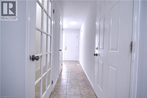 Corridor featuring a textured ceiling and light tile patterned flooring - 919 Zeller Crescent, Kitchener, ON - Indoor Photo Showing Other Room