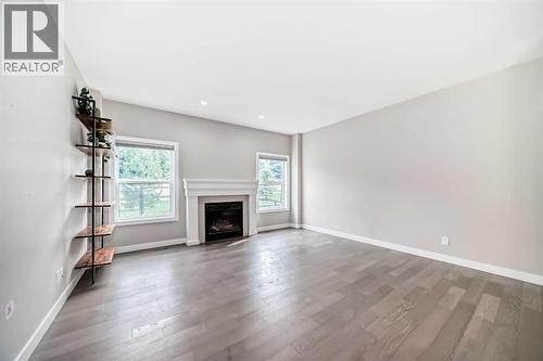 41 Shawnee Green Sw, Calgary, AB - Indoor Photo Showing Living Room With Fireplace