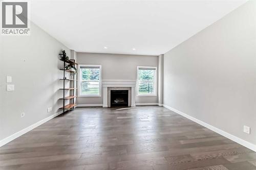 41 Shawnee Green Sw, Calgary, AB - Indoor Photo Showing Living Room With Fireplace