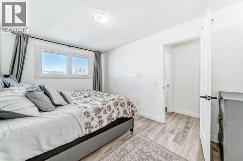 Primary bedroom window overlooks backyard - 216 Pinecrest Crescent Ne, Calgary, AB - Indoor Photo Showing Bedroom