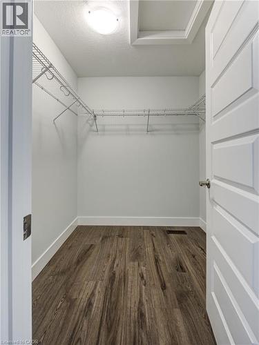 Walk in closet featuring dark wood-type flooring - 2527 Holbrook Drive, London, ON - Indoor With Storage