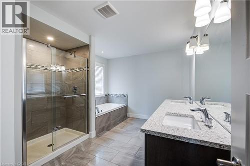 Bathroom with a shower stall, a garden tub, and double vanity - 2527 Holbrook Drive, London, ON - Indoor Photo Showing Bathroom