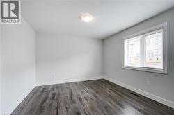 Spare room with dark wood finished floors and baseboards - 