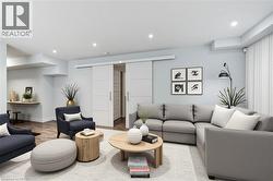 Living area with wood finished floors and recessed lighting - 