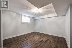 Empty room with dark wood-style floors and a textured ceiling - 