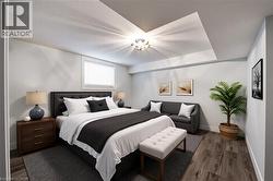 Bedroom with dark wood-type flooring and baseboards - 