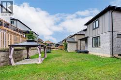 View of yard featuring a residential view, a gazebo, and a patio area - 