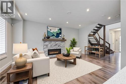 Living area featuring stairs, wood finished floors, a fireplace, and recessed lighting - 2527 Holbrook Drive, London, ON - Indoor Photo Showing Living Room With Fireplace
