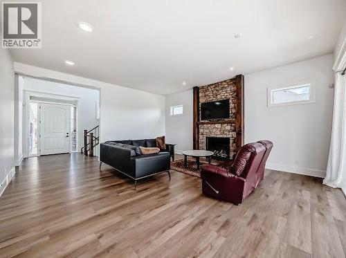 60 Junegrass Terrace, Rural Rocky View County, AB - Indoor Photo Showing Living Room With Fireplace