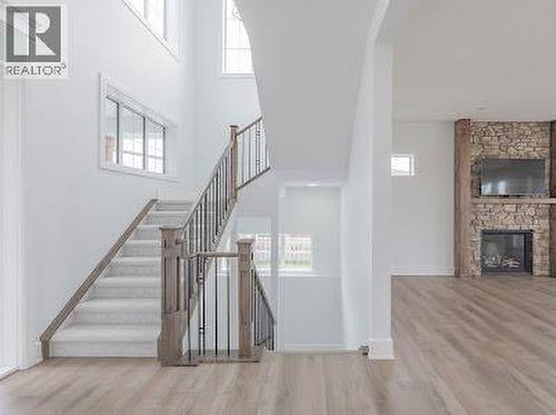 60 Junegrass Terrace, Rural Rocky View County, AB - Indoor Photo Showing Other Room With Fireplace
