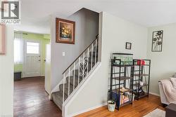 Stairs with wood-type flooring and baseboards - 
