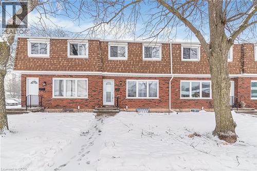 View of front of home featuring mansard roof, roof with shingles, and brick siding - 48 Riverdale Drive Unit# 2, Hamilton, ON - Outdoor With Facade