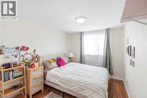 Bedroom with dark wood-style flooring and baseboards - 48 Riverdale Drive Unit# 2, Hamilton, ON - Indoor Photo Showing Bedroom