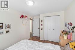 Bedroom featuring wood finished floors and a closet - 