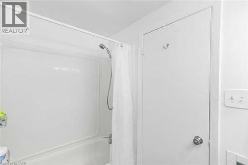 Full bathroom featuring shower / bathtub combination with curtain - 48 Riverdale Drive Unit# 2, Hamilton, ON - Indoor Photo Showing Bathroom