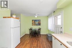 Dining space featuring dark wood-type flooring and a ceiling fan - 
