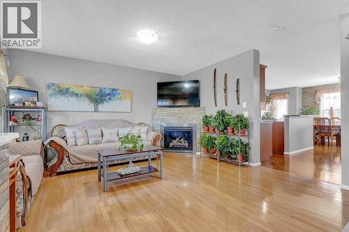 241 Covemeadow Road Ne, Calgary, AB - Indoor Photo Showing Living Room With Fireplace