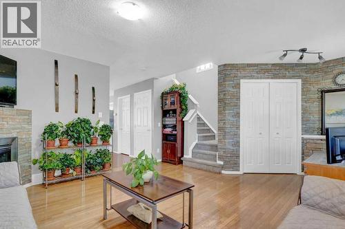 241 Covemeadow Road Ne, Calgary, AB - Indoor Photo Showing Living Room With Fireplace