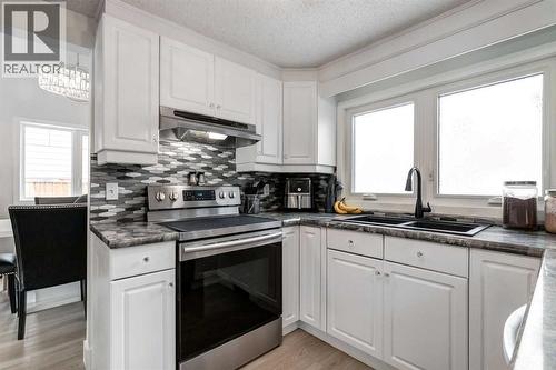 16 Woodgate Close Sw, Calgary, AB - Indoor Photo Showing Kitchen With Double Sink