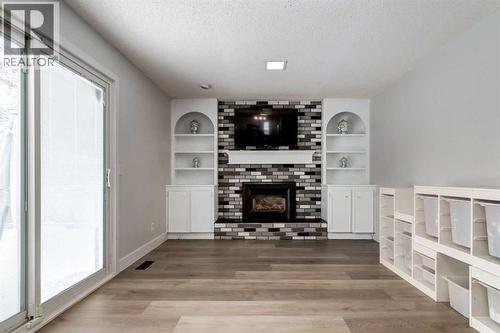 16 Woodgate Close Sw, Calgary, AB - Indoor Photo Showing Living Room With Fireplace