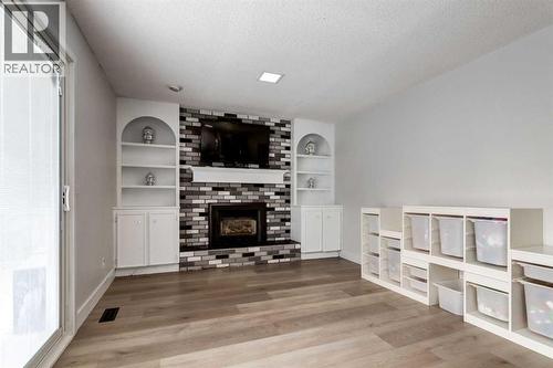 16 Woodgate Close Sw, Calgary, AB - Indoor Photo Showing Living Room With Fireplace