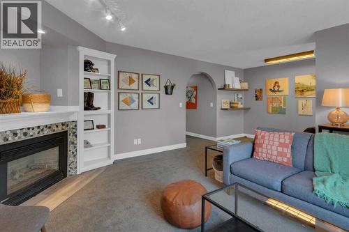 RECREATION ROOM - 40 Hunters Gate, Okotoks, AB - Indoor Photo Showing Living Room With Fireplace