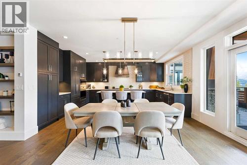 Dining into Ktichen - 102, 101A Stewart Creek Rise, Canmore, AB - Indoor Photo Showing Dining Room