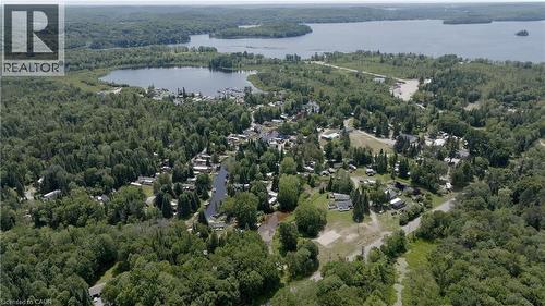 View of property location featuring a heavily wooded area and a large body of water - 85 Hutchinson Beach Road Unit# B56, Huntsville, ON - Outdoor With Body Of Water With View