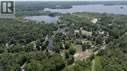 View of property location featuring a heavily wooded area and a large body of water - 
