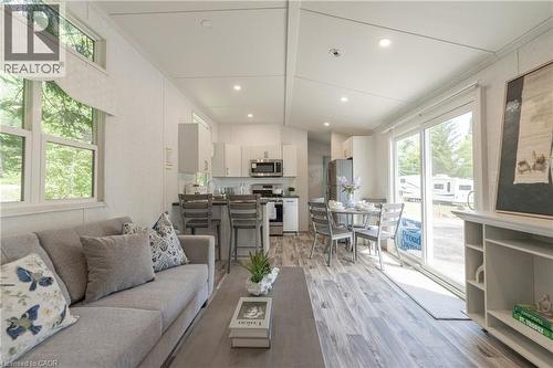 Living area featuring recessed lighting, light wood-type flooring, ornamental molding, and lofted ceiling - 85 Hutchinson Beach Road Unit# B56, Huntsville, ON - Indoor Photo Showing Living Room