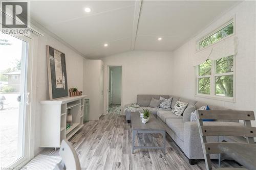 Living room featuring vaulted ceiling, wood finished floors, and recessed lighting - 85 Hutchinson Beach Road Unit# B56, Huntsville, ON - Indoor