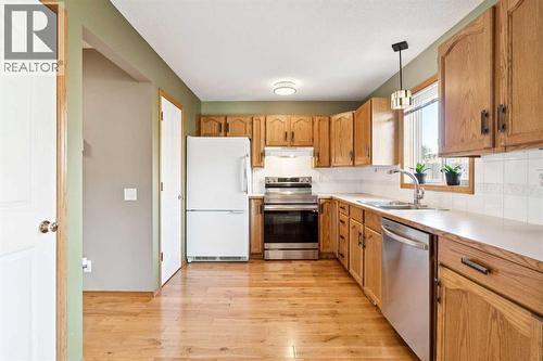 56 West Terrace Road, Cochrane, AB - Indoor Photo Showing Kitchen With Double Sink