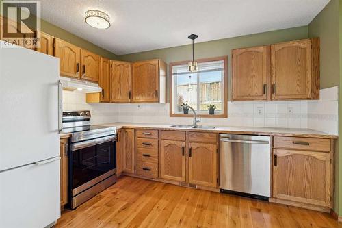 56 West Terrace Road, Cochrane, AB - Indoor Photo Showing Kitchen With Double Sink