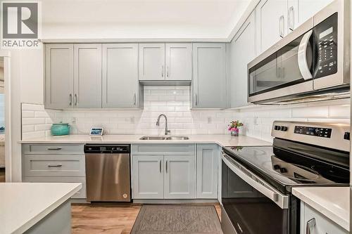 316, 200 Shawnee Square Sw, Calgary, AB - Indoor Photo Showing Kitchen With Stainless Steel Kitchen With Double Sink With Upgraded Kitchen