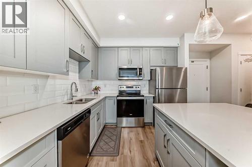 316, 200 Shawnee Square Sw, Calgary, AB - Indoor Photo Showing Kitchen With Stainless Steel Kitchen With Double Sink