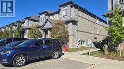 View of property featuring uncovered parking and a residential view - 