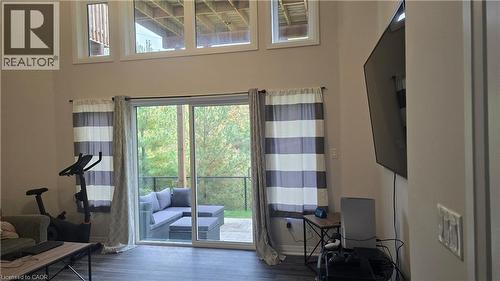 Great room  with plenty of natural light, hardwood / wood-style floors and sliding door to private patio - 115 South Creek Drive Unit# 15D, Kitchener, ON - Indoor