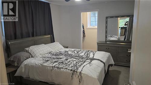 Bedroom with carpet,  a ceiling fan and walk-in closet with window - 115 South Creek Drive Unit# 15D, Kitchener, ON - Indoor Photo Showing Bedroom