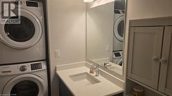 Laundry area featuring stacked washing machine and dryer - 