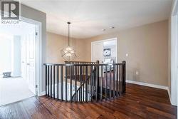Central upper level hallway with glamorous chandelier. - 