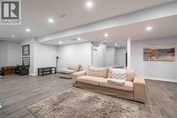 Open concept lower level Family Room with recessed lighting and luxury vinyl flooring - 