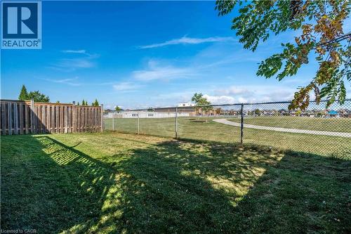 Fenced rear yard overlooking school greenspace - 51 Showcase Drive, Hamilton, ON - Outdoor