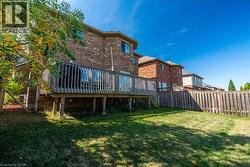 Alternate view of rear of home plus rear yard lawn. - 