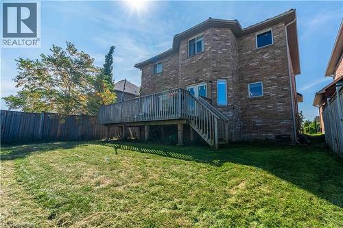 Rear view of house with brick siding, a wooden deck, and stairway - 51 Showcase Drive, Hamilton, ON - Outdoor With Deck Patio Veranda