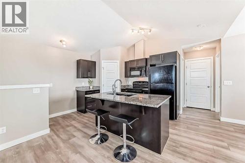 Central island with Seating - 11302, 2781 Chinook Winds Drive Sw, Airdrie, AB - Indoor Photo Showing Kitchen
