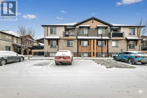 2 Parking stalls 1 next to unit and the other just across - 11302, 2781 Chinook Winds Drive Sw, Airdrie, AB - Outdoor With Balcony With Facade