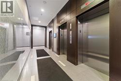 Corridor featuring elevator, recessed lighting, and light tile patterned floors - 