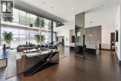 Party Room featuring a towering ceiling, a wall of windows, and recessed lighting - 