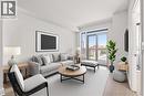 Living room with light wood-style flooring and baseboards - 55 Speers Road Unit# 415, Oakville, ON  - Indoor Photo Showing Living Room 